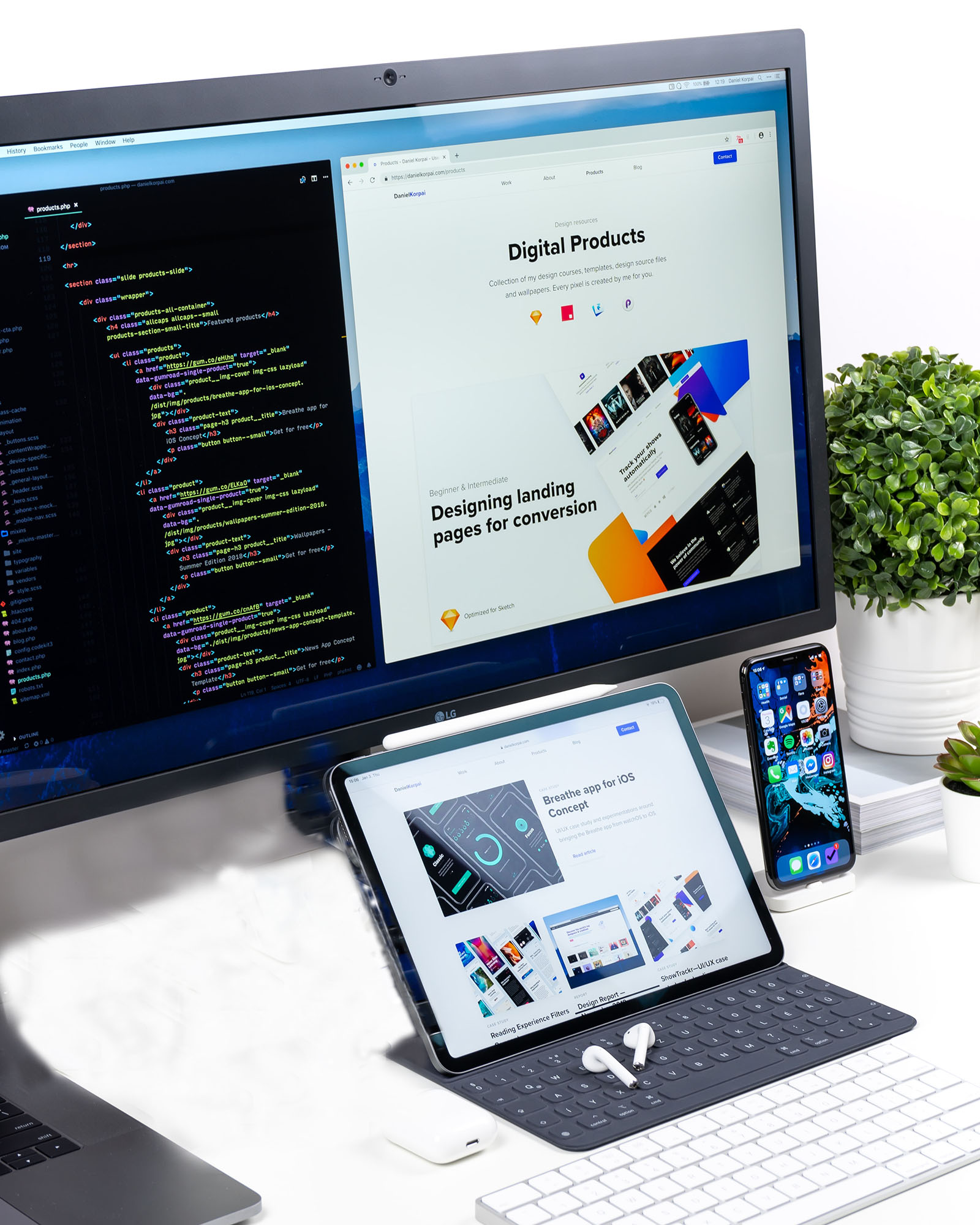 A laptop is on a desk, beside a notepad and pen.  The laptop screen shows coding in process.